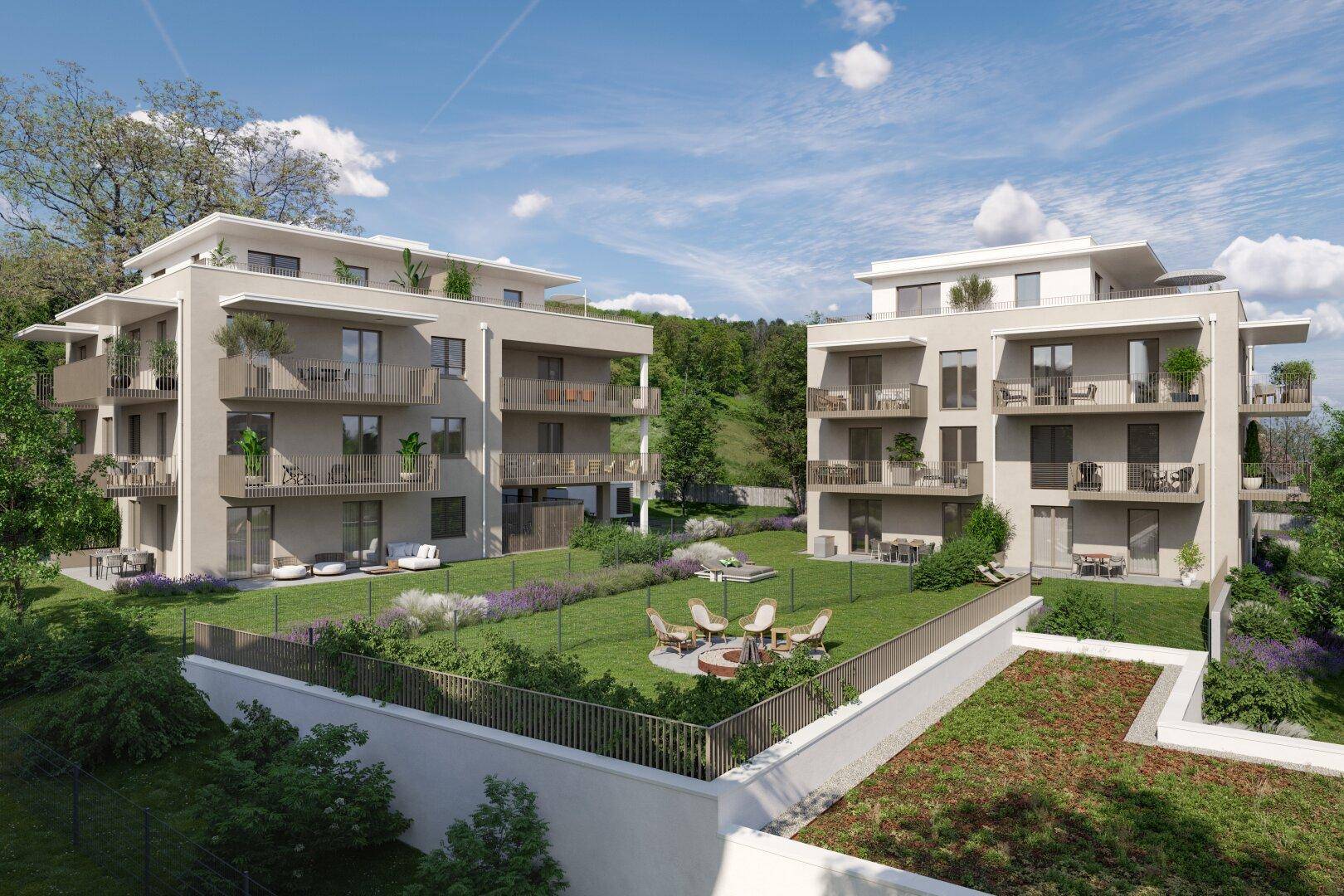 Zwei moderne Wohngebäude mit gemeinsamer Grünfläche, Sitzgelegenheiten und Balkonen.