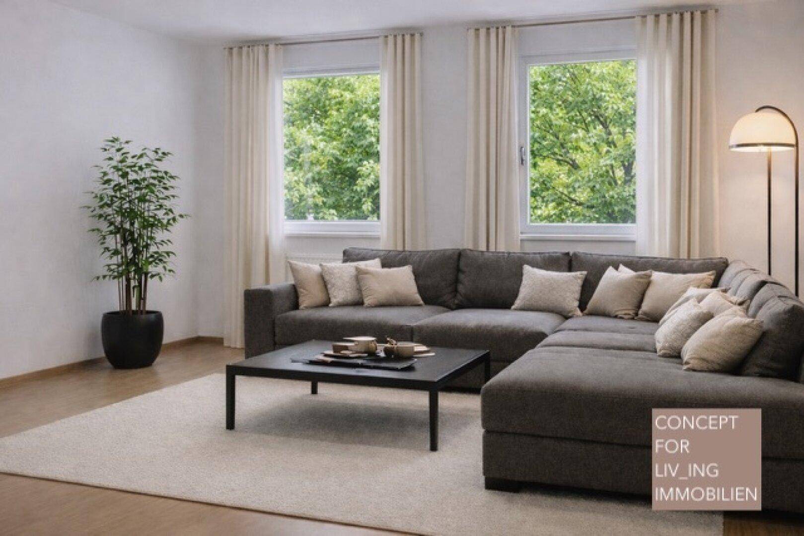 Gemütliches Wohnzimmer mit großem Ecksofa, Couchtisch und Blick ins Grüne.