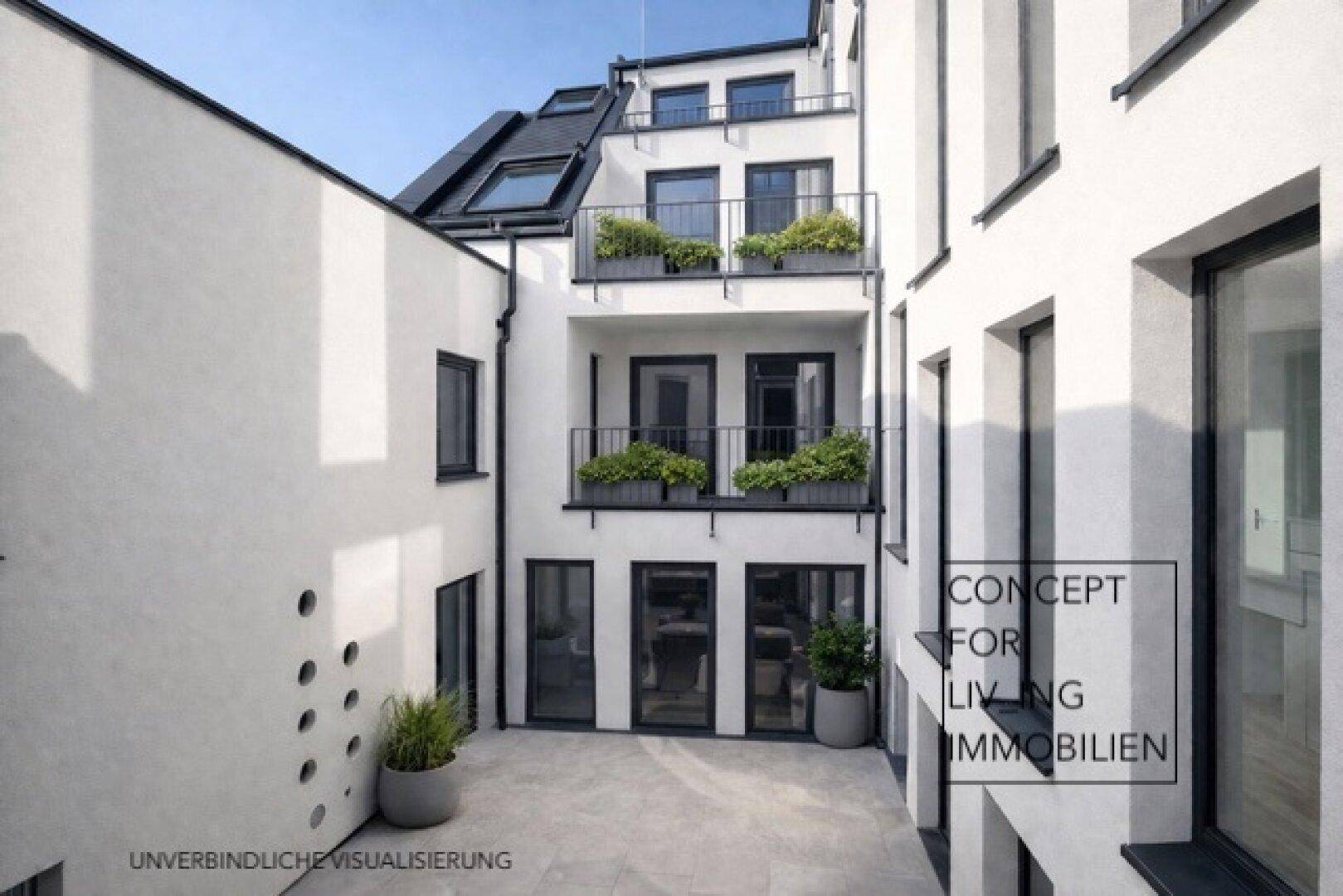 Innenhof mit moderner Gestaltung, gepflastertem Bereich und dekorativen Pflanzen.