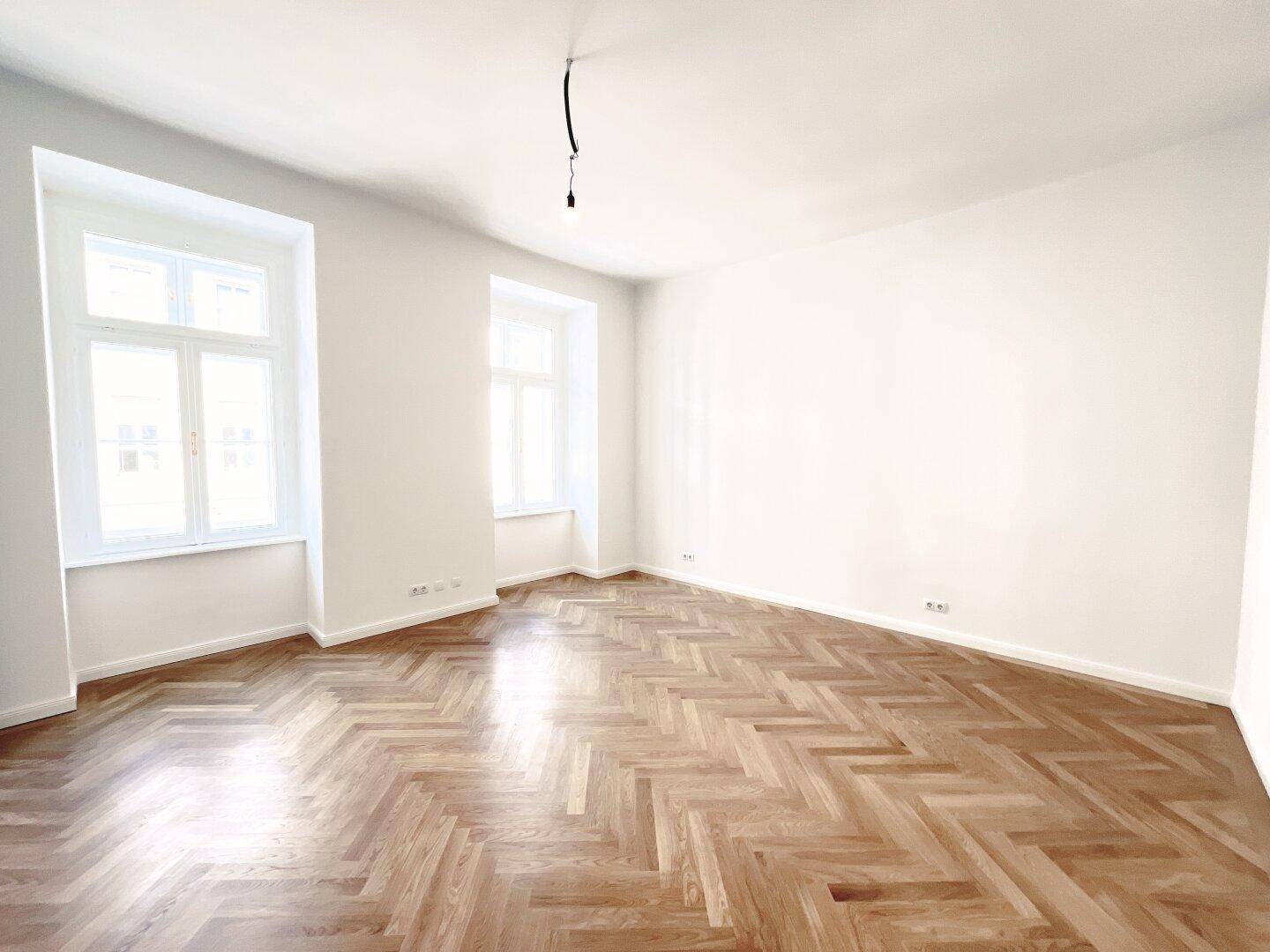 Helles, geräumiges Zimmer mit Fischgrätparkett und zwei hohen Fenstern, das vielseitig nutzbar ist.