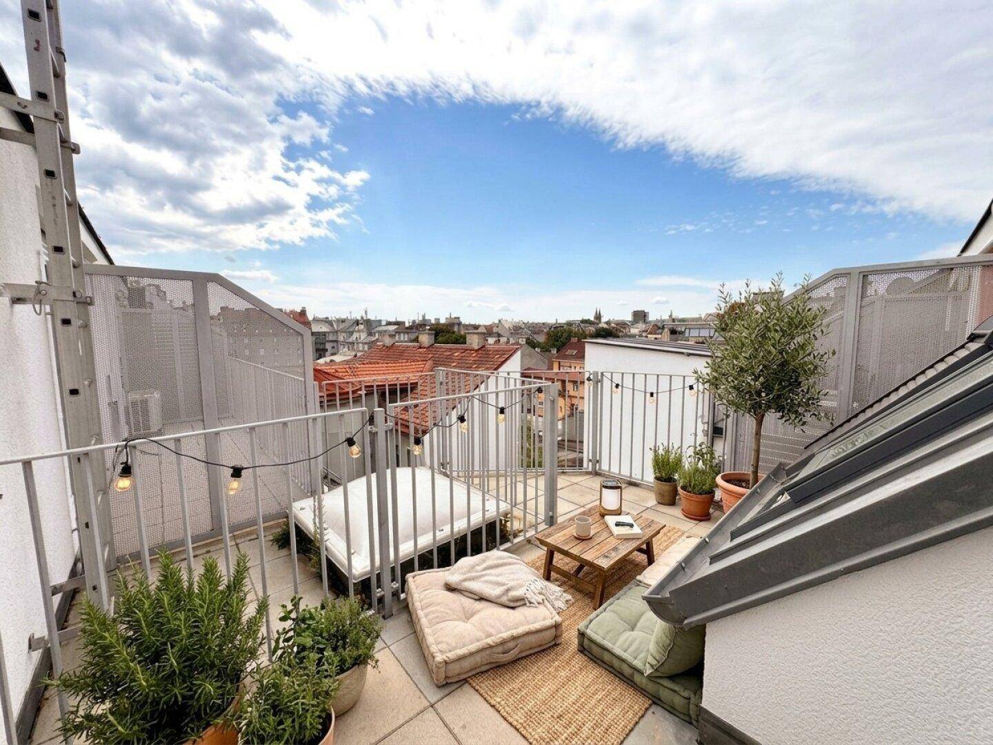 Gemütliche Dachterrasse mit Stadtblick, Pflanzen und bequemen Sitzgelegenheiten.