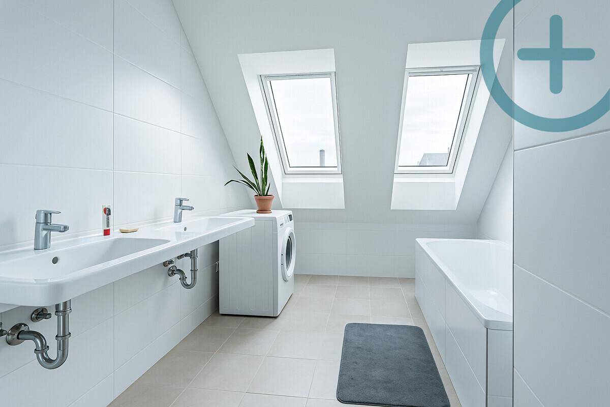 Modernes Badezimmer mit Badewanne, Doppelwaschbecken, Waschmaschine und Dachfenstern.