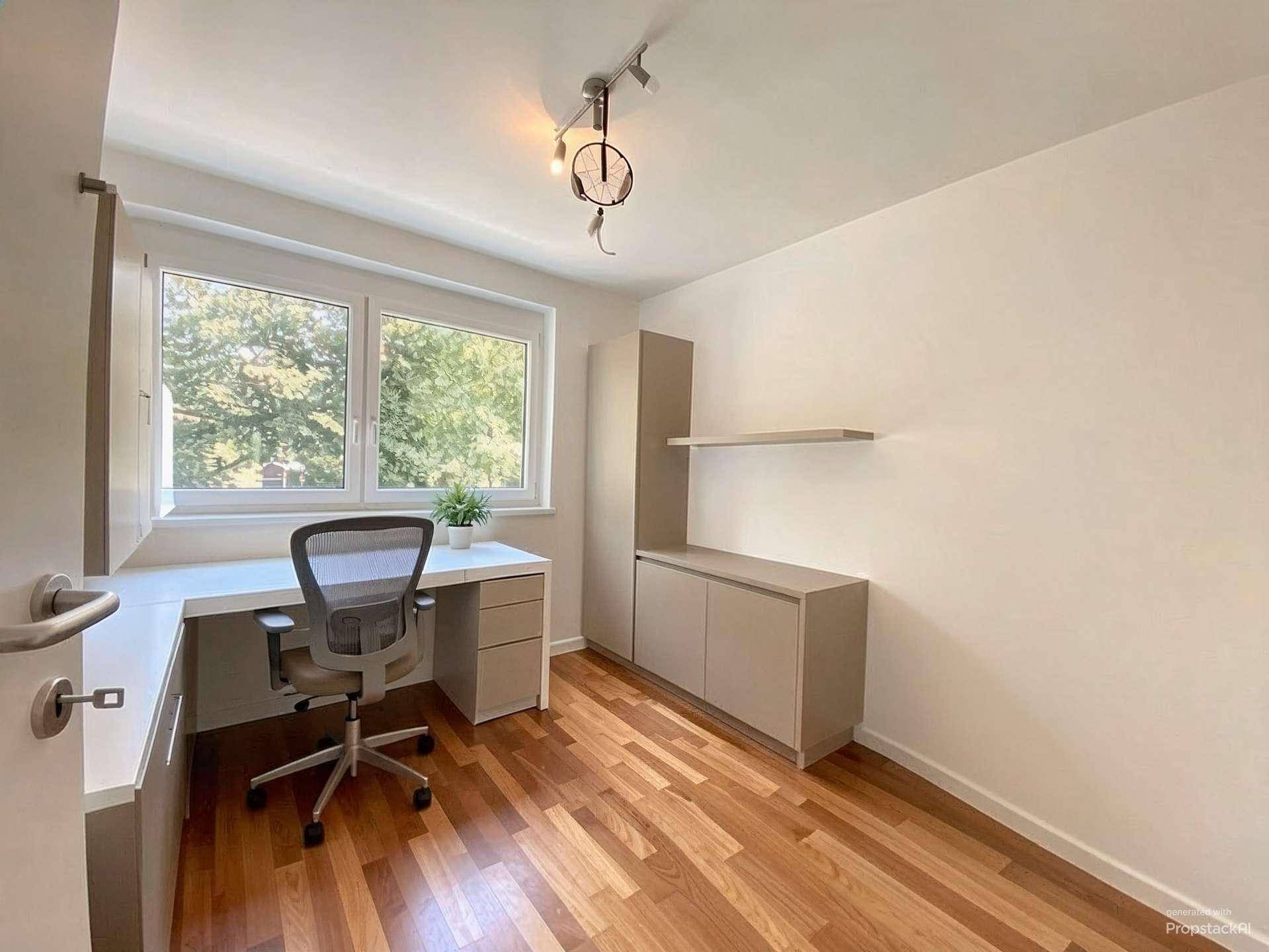Funktionales Arbeitszimmer mit Holzboden, Schreibtisch und Fenster mit Blick ins Grüne.