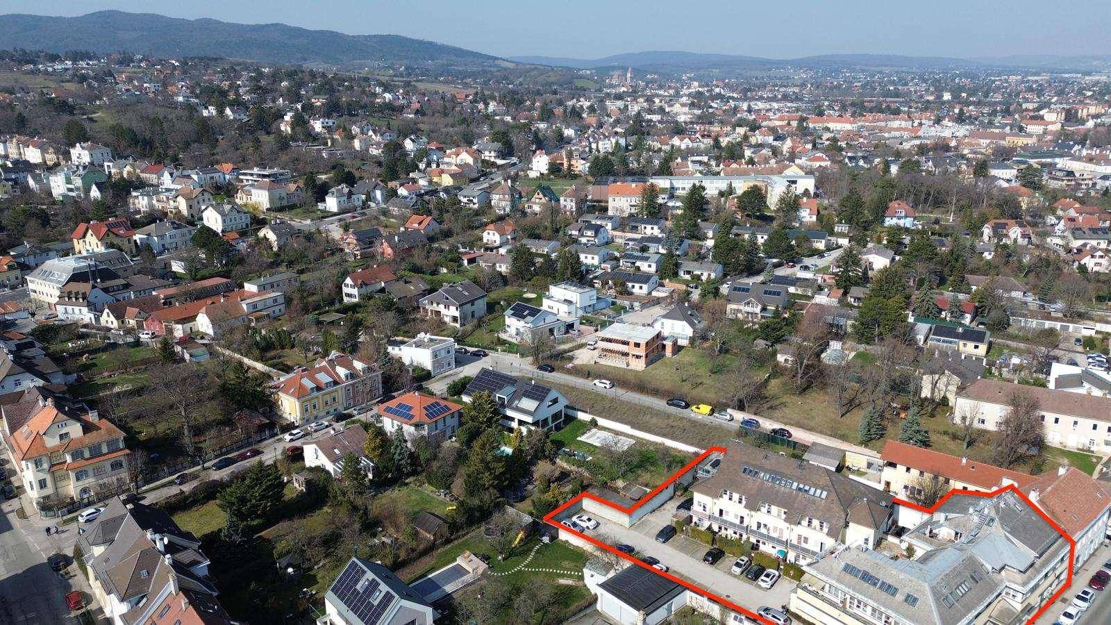 Weitläufige Luftaufnahme der Wohngegend mit Häusern und viel Grün.