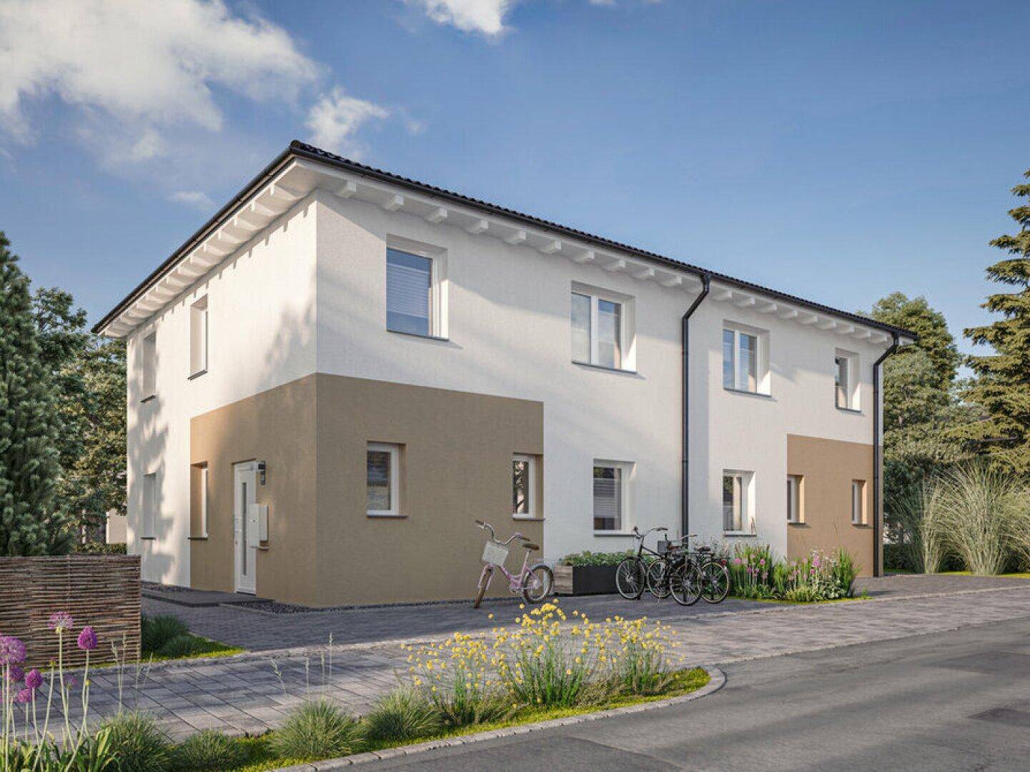 Vorderansicht der modernen Doppelhaushälfte mit heller Fassade, Einfahrt und Grünflächen.