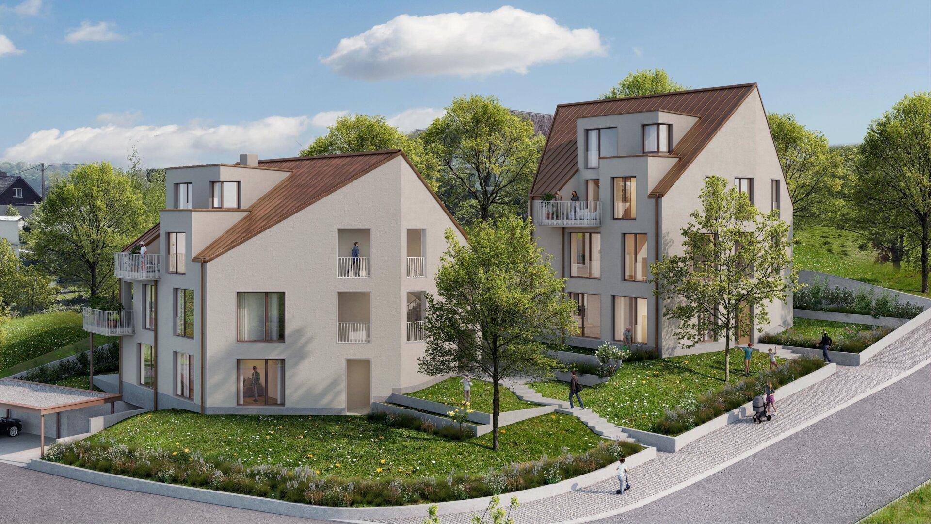 Moderne Wohngebäude mit Balkonen und einem Carport, eingebettet in eine grüne Umgebung.