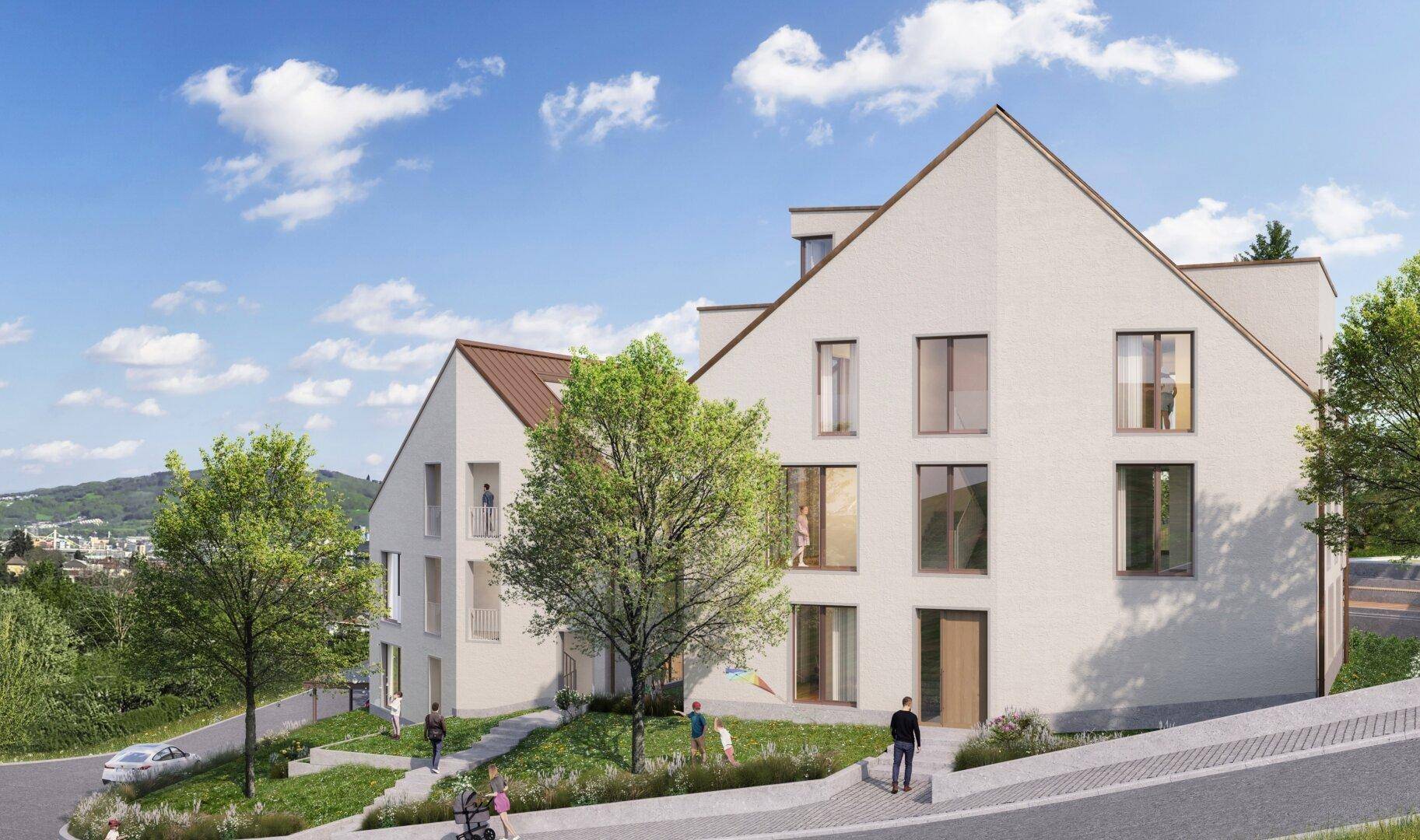 Ansicht der modernen Wohngebäude von der Straße, umgeben von viel Grün und Bäumen.