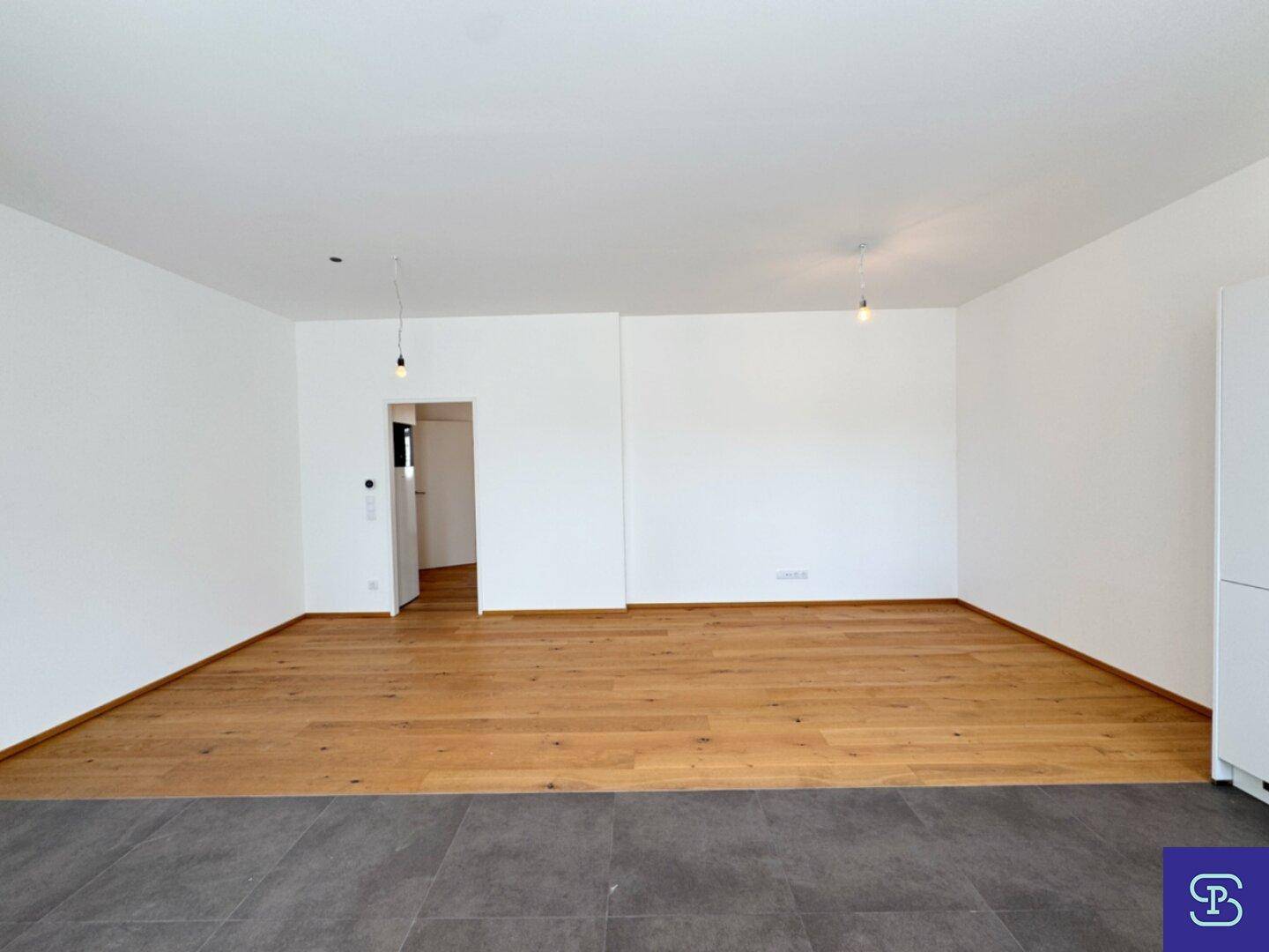 Heller Wohnbereich mit Eichenparkett und weiß gestrichenen Wänden, ideal für Entspannung.