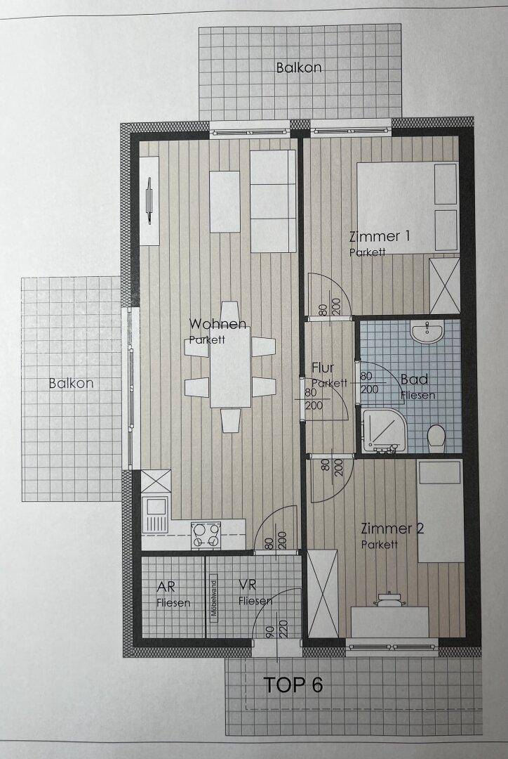 Grundriss einer Wohnung mit zwei Zimmern, offenem Wohnbereich, Bad und zwei Balkonen.