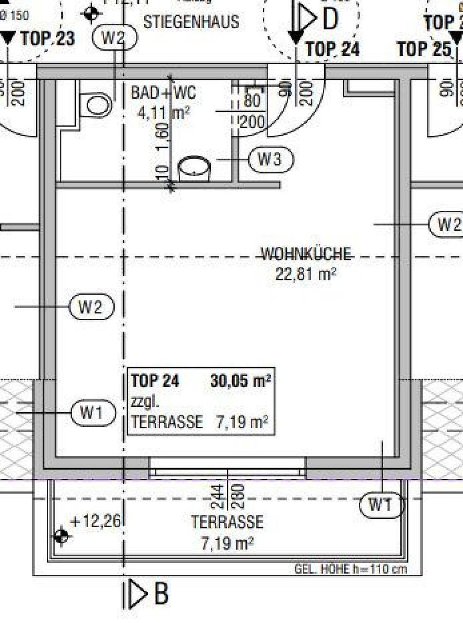 Grundriss einer Wohnung mit offener Wohnküche, Bad und Terrasse.