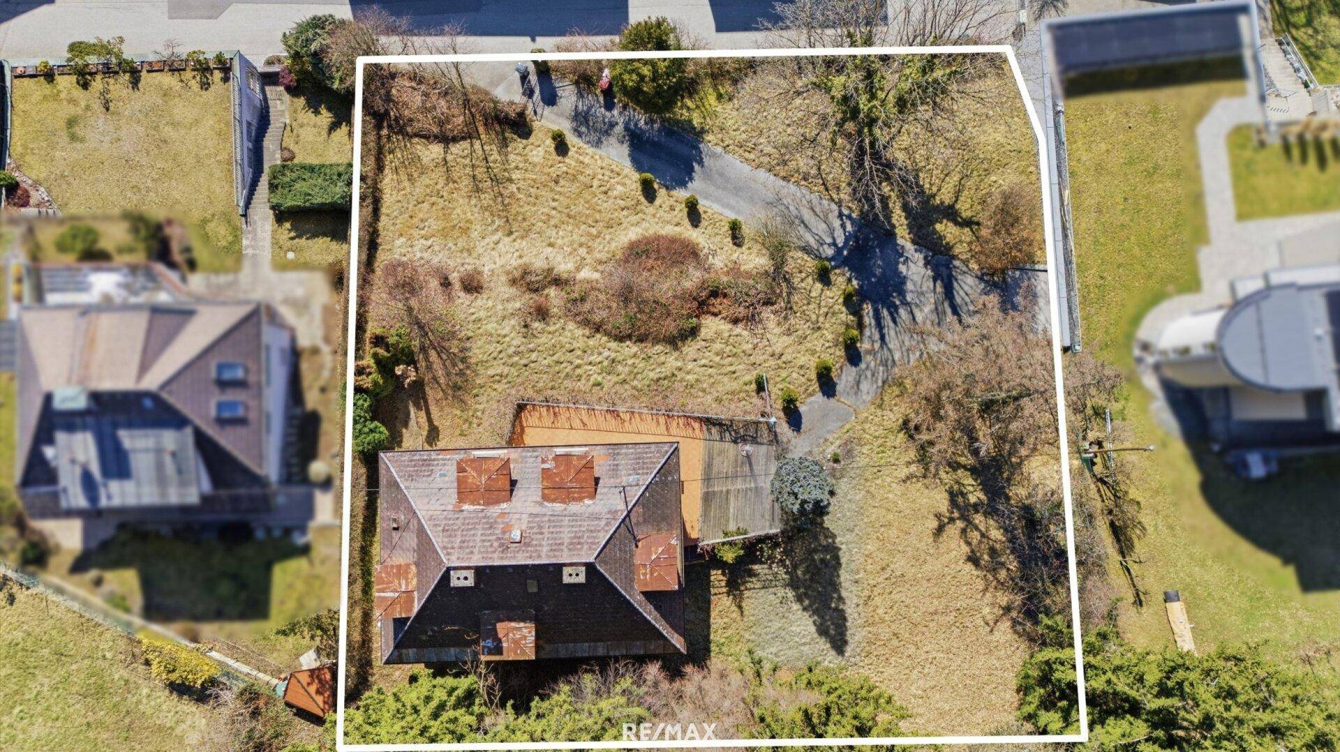 Draufsicht auf das Haus mit Satteldach und weitläufiger Zufahrt auf dem Grundstück.