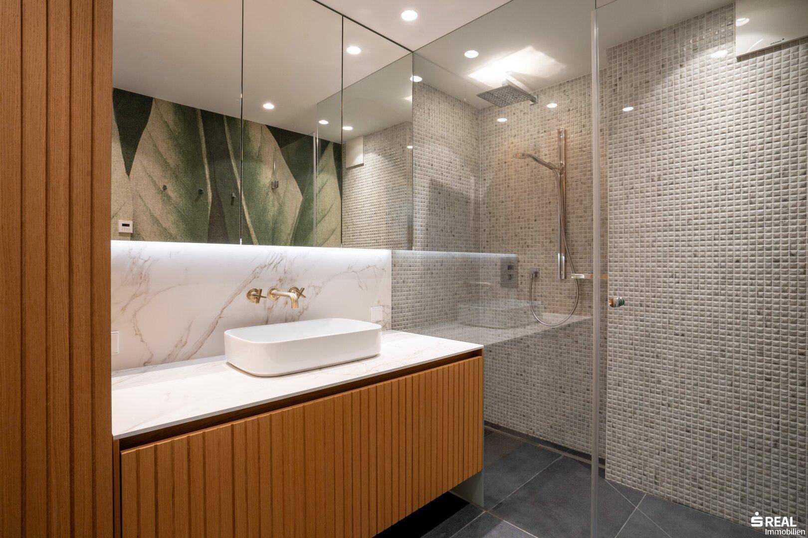 Modernes Badezimmer mit begehbarer Dusche, Einzelwaschbecken und stilvollen Fliesen.