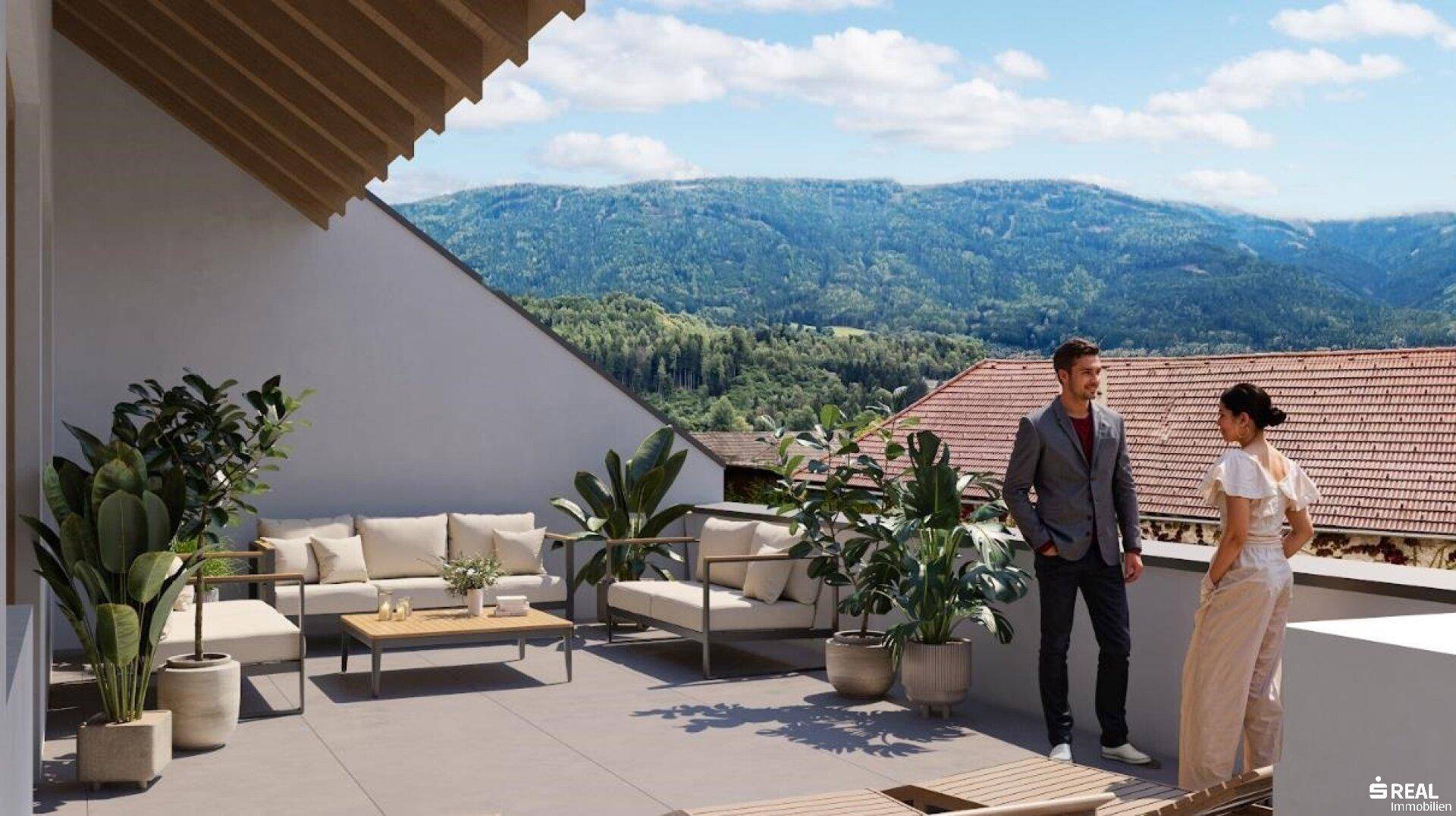 Großzügige Dachterrasse mit bequemen Loungemöbeln und atemberaubendem Blick auf die umliegende Berglandschaft.
