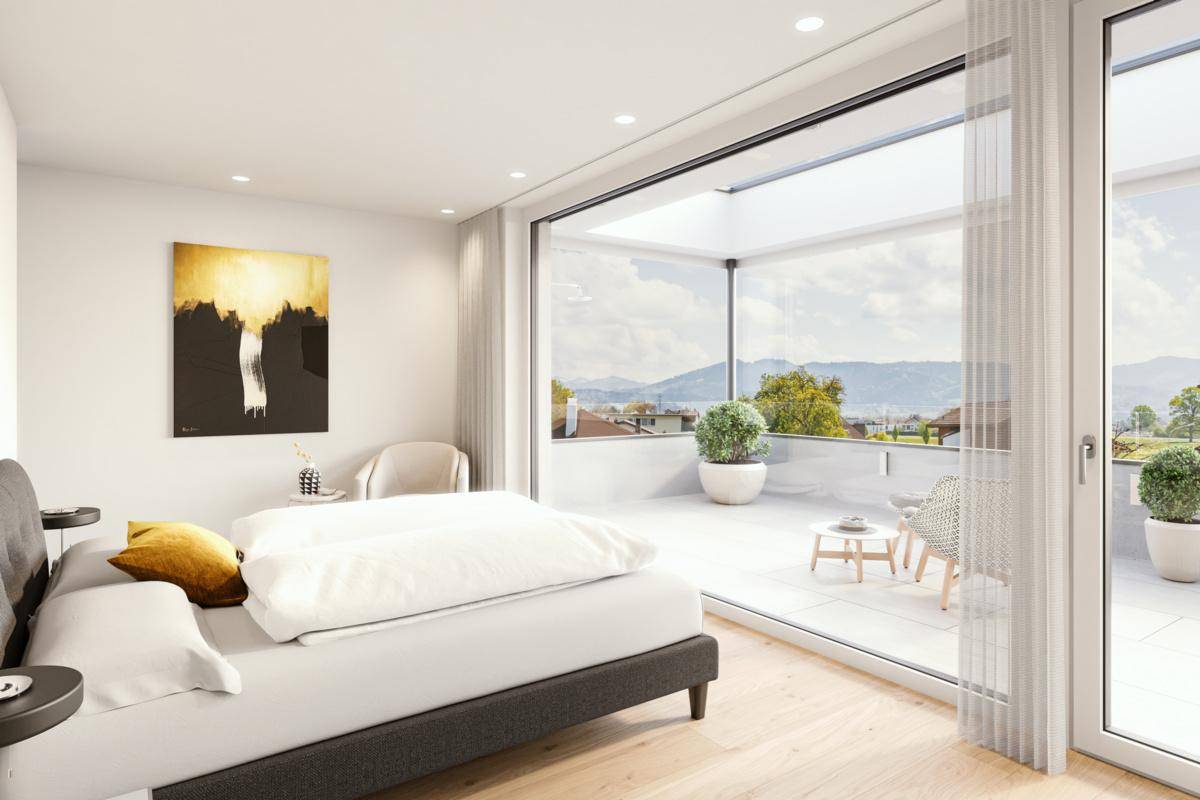 Helles Schlafzimmer mit Zugang zu einer großen Terrasse und malerischem Bergblick.
