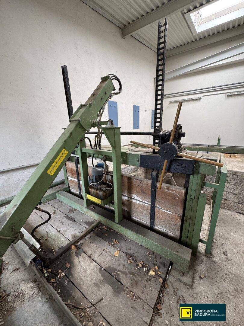 Industrielle Maschine mit Holzrahmen und mechanischen Komponenten, möglicherweise eine Presse.