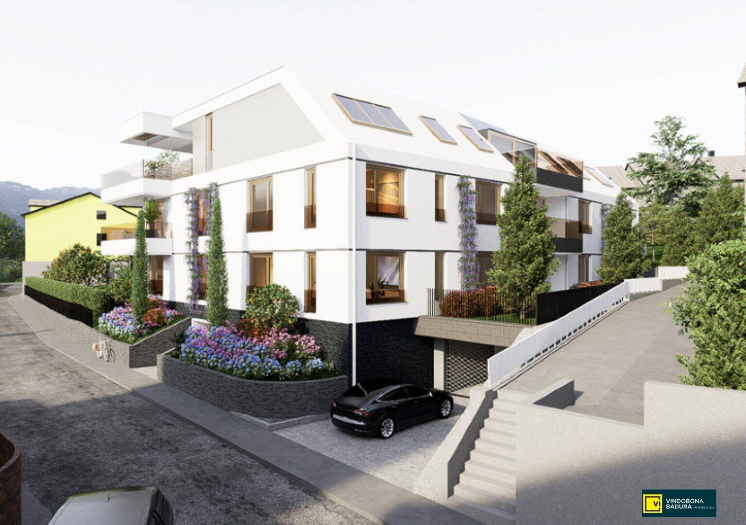 Neubau mit moderner Architektur, Tiefgaragenzufahrt und gepflegter Außenanlage.