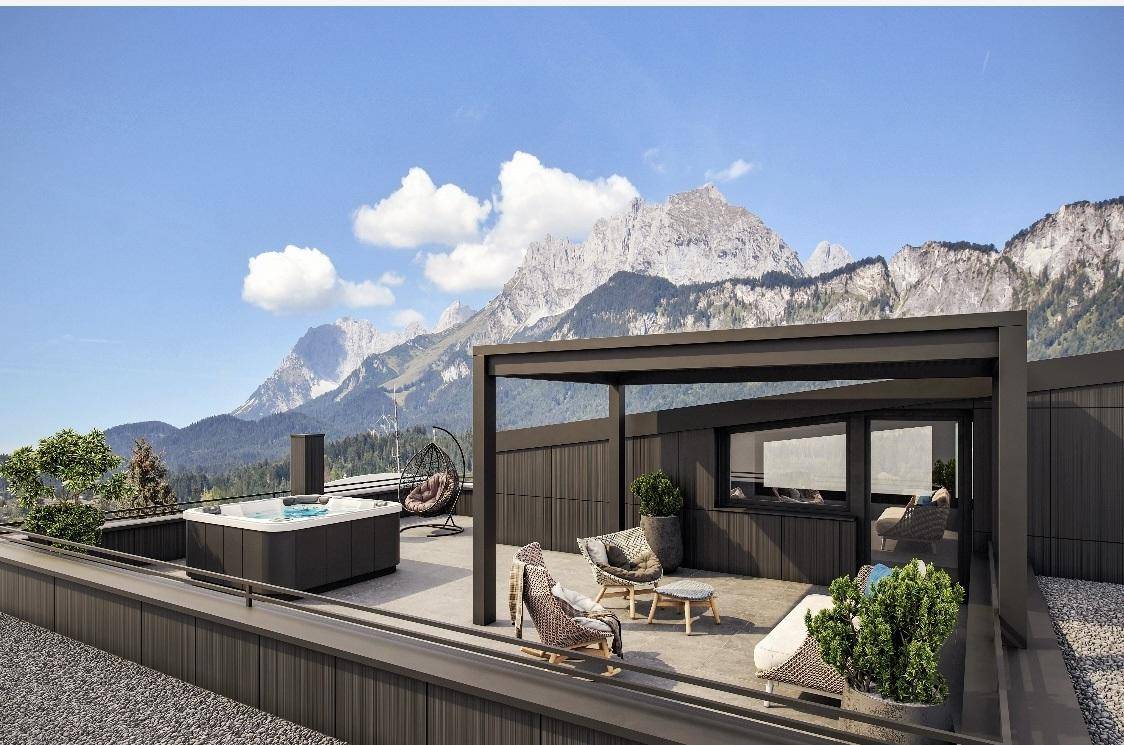 Exklusive Dachterrasse mit Whirlpool, gemütlicher Sitzecke und atemberaubendem Bergblick.