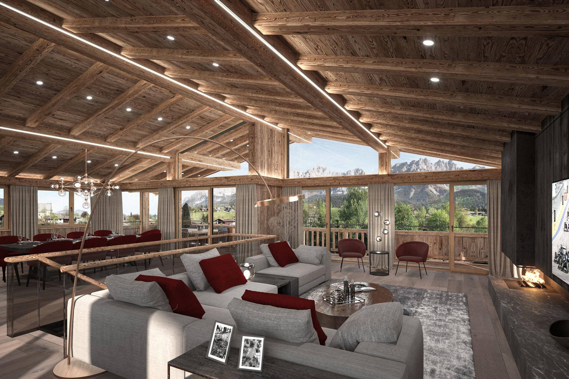 Gemütlicher Wohnbereich mit bequemen Sofas, Kamin und spektakulärem Bergblick durch große Fenster.