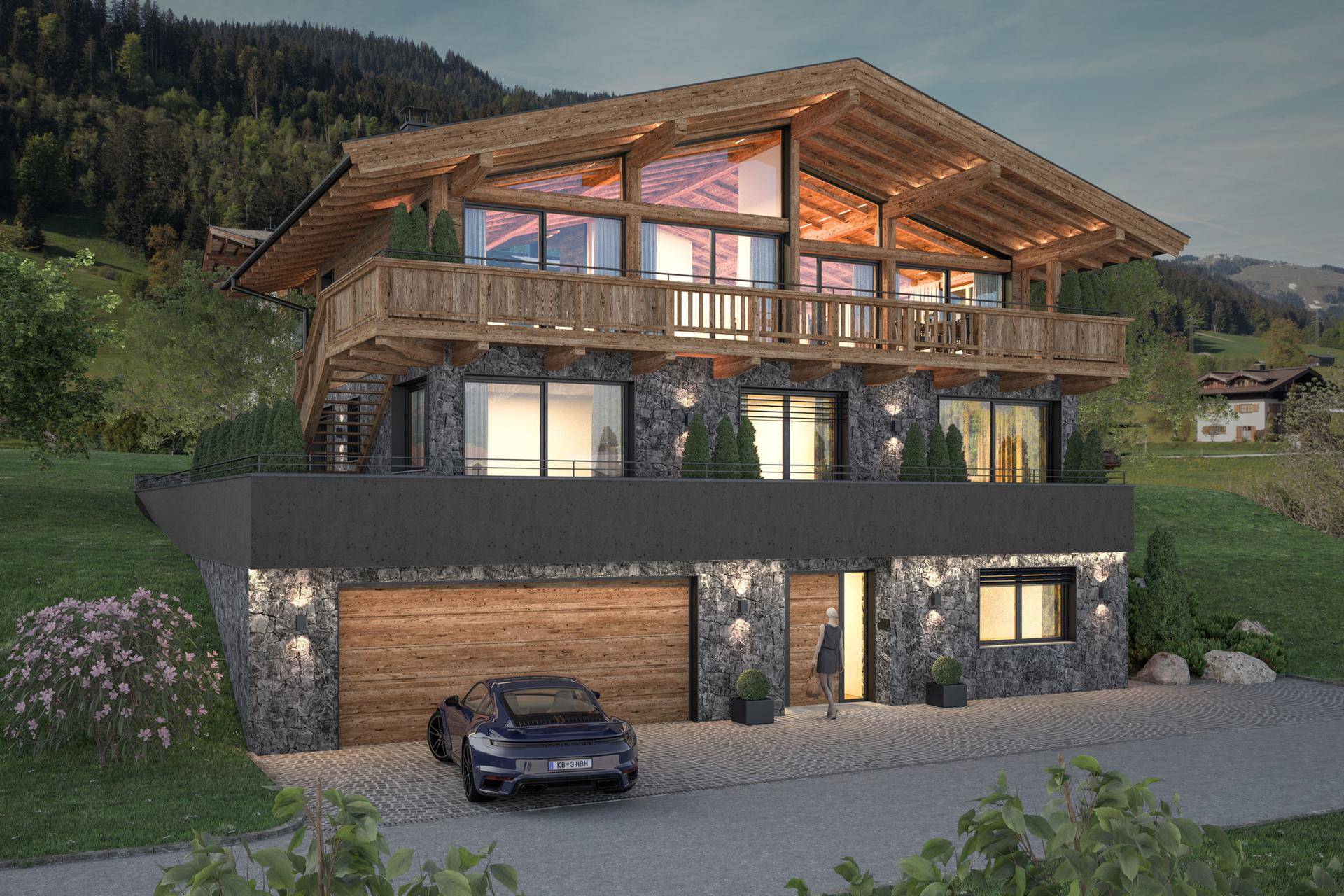 Abendliche Ansicht des luxuriösen Chalets mit beleuchteter Fassade und integrierter Garage in den Bergen.