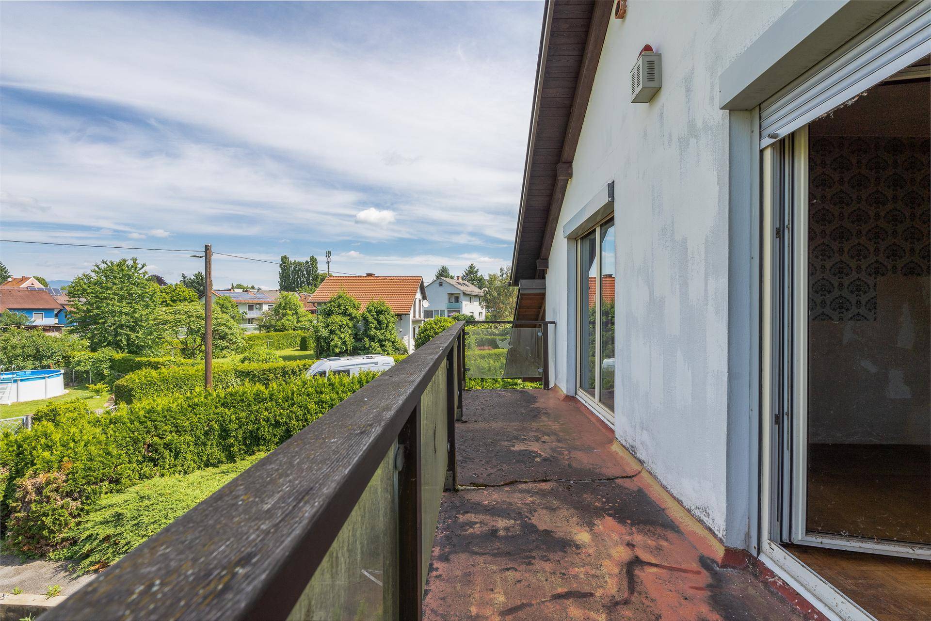 Geräumiger Balkon mit weitem Blick über die grüne Umgebung und Nachbarschaft.