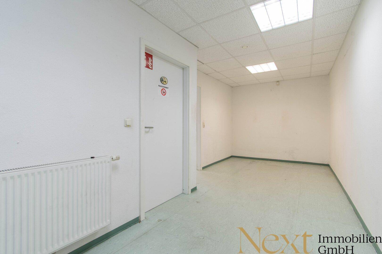 Heller Flur mit Heizkörper und Türen zu weiteren Räumen, bietet Zugang zu verschiedenen Bereichen.