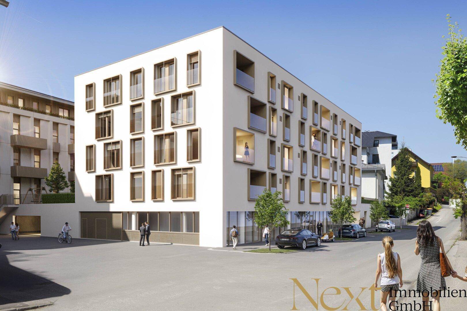 Moderne Wohnanlage mit klarer Architektur, großen Fenstern und Balkonen in urbaner Umgebung.