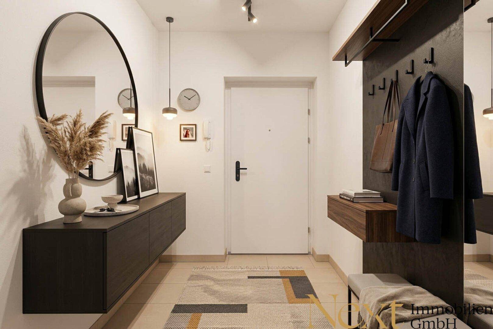 Moderner Eingangsbereich mit großem Spiegel, Garderobe und heller Beleuchtung, einladend gestaltet.