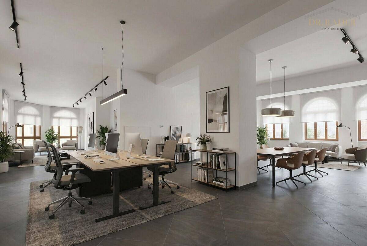 Modernes Großraumbüro mit mehreren Arbeitsplätzen, Besprechungsbereichen und viel Tageslicht.