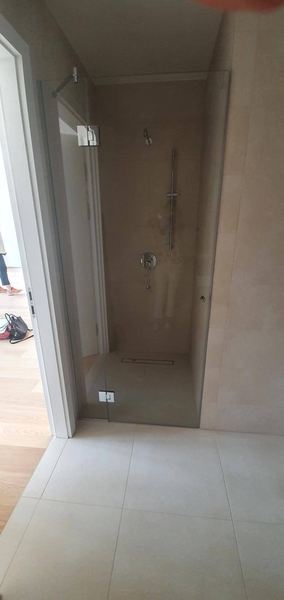Zeitgemäßes Badezimmer mit einer geräumigen begehbaren Dusche und Glasabtrennung.