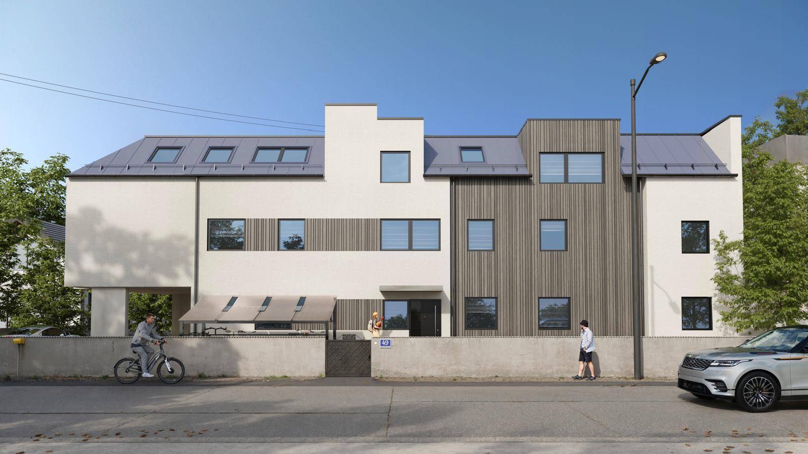 Moderne Wohnanlage mit heller Fassade, Holzverkleidung und Dachfenstern an der Straße.