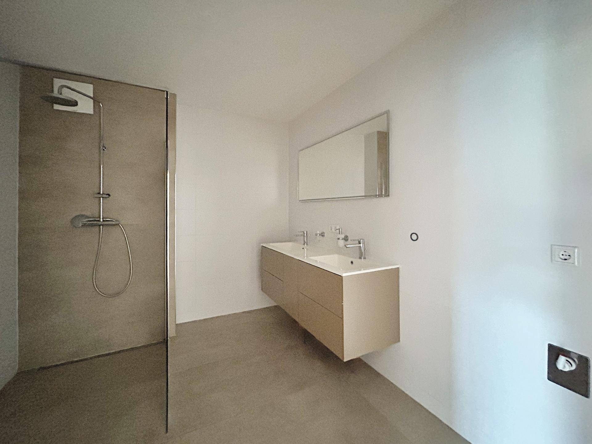 modernes Badezimmer mit Dusche und Anschluß für Waschmaschine