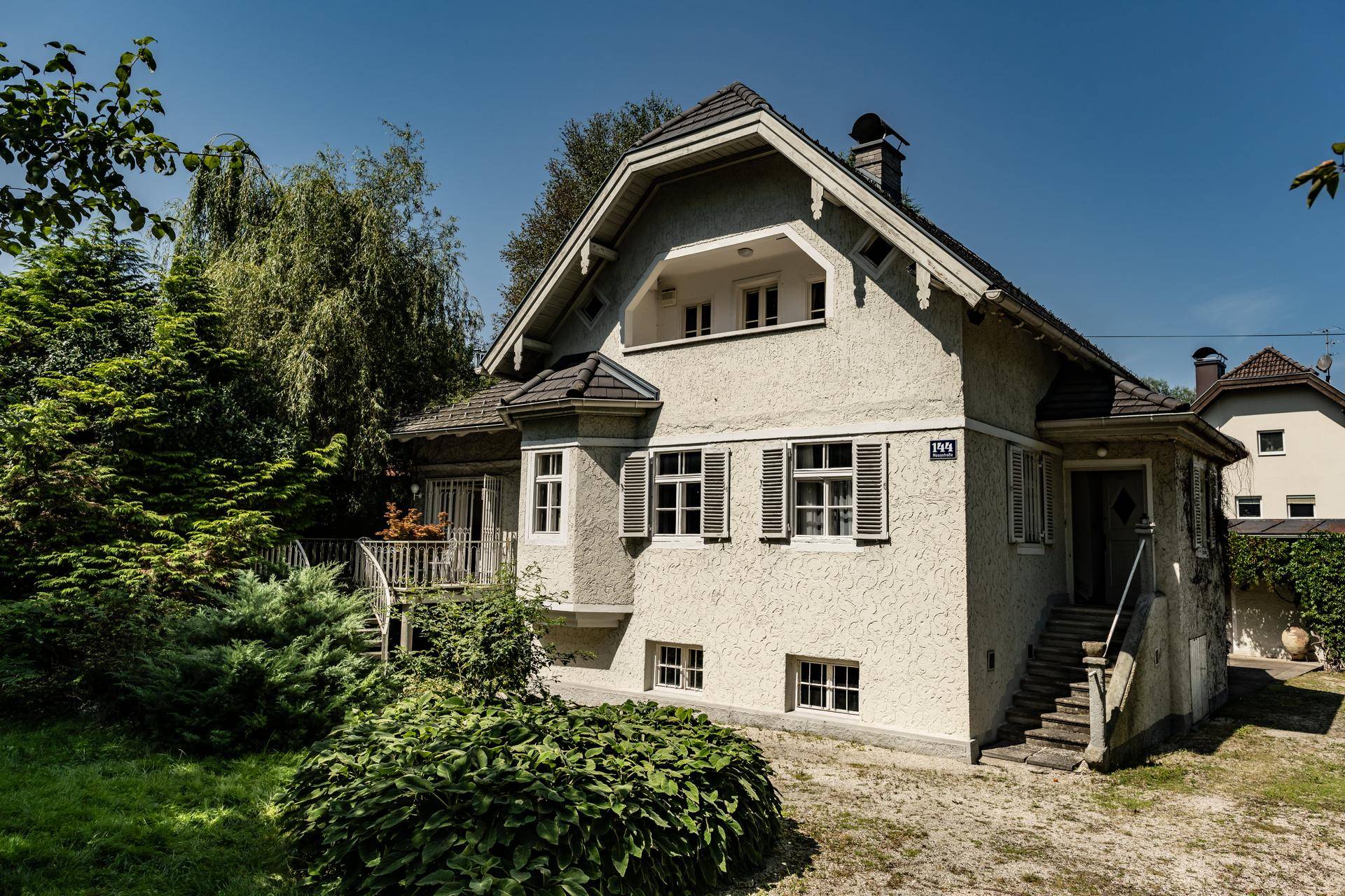 Gesamtansicht des Hauses mit Eingangsbereich, Außentreppe und gepflegtem Vorgarten.