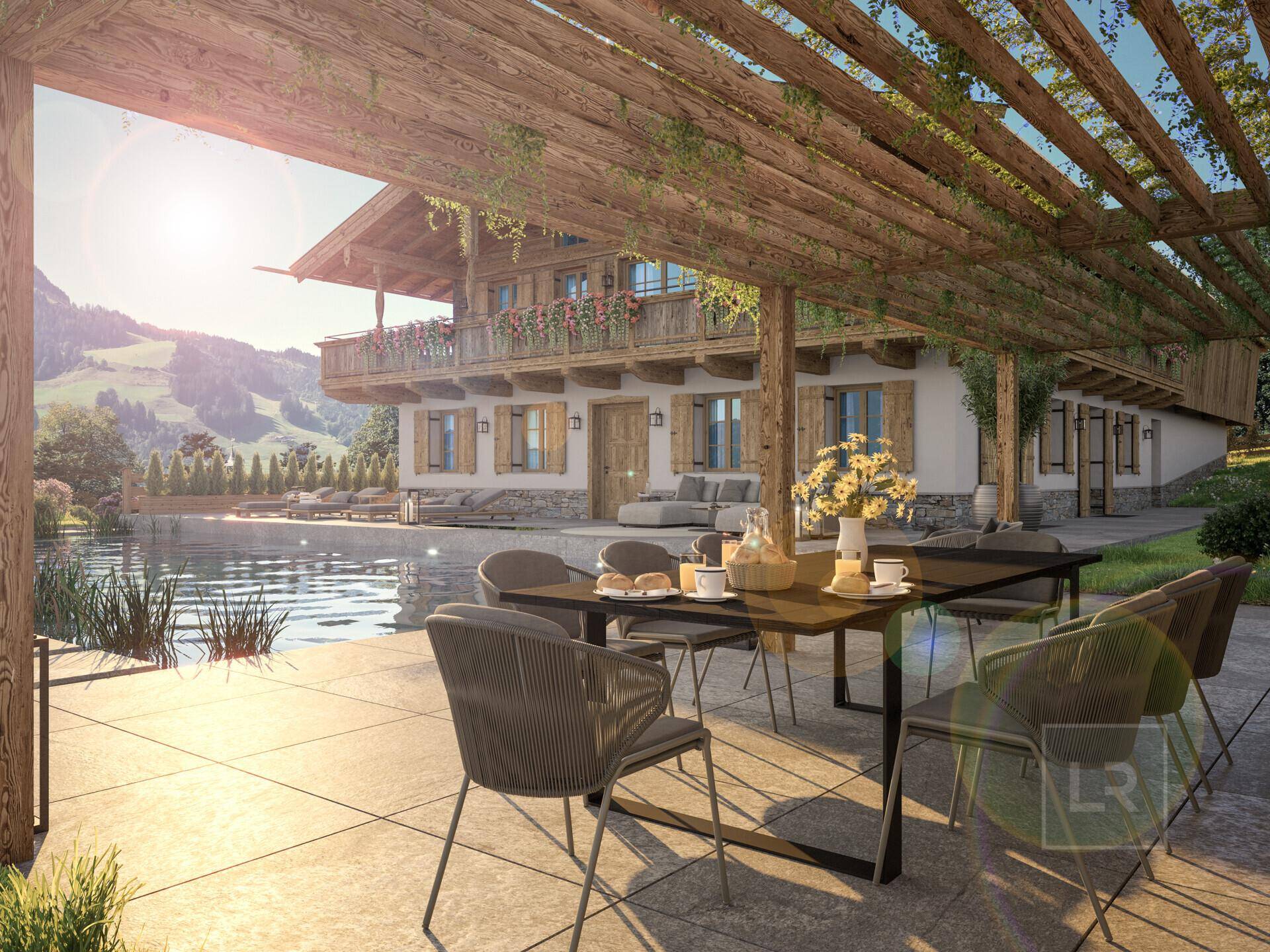 Sonnige Terrasse mit Esstisch unter einer Pergola, Infinity-Pool und herrlichem Bergblick.
