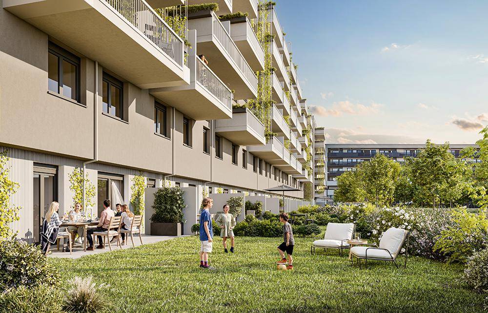 Moderne Wohnanlage mit großem Gemeinschaftsgarten und sonniger Terrasse für Bewohner.