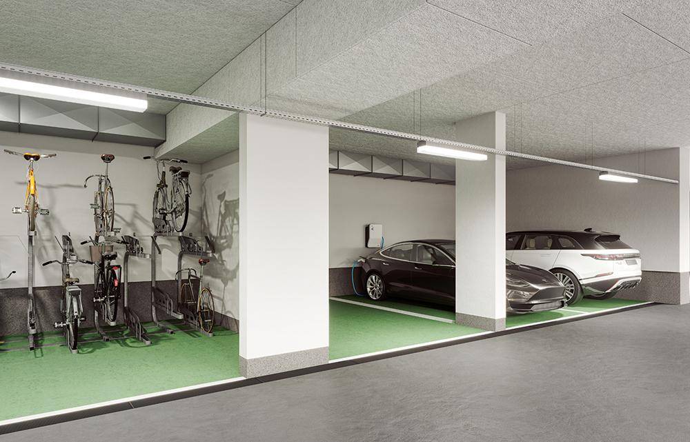 Tiefgarage mit Stellplätzen für Autos, Fahrradständern und einer Ladestation für Elektrofahrzeuge.