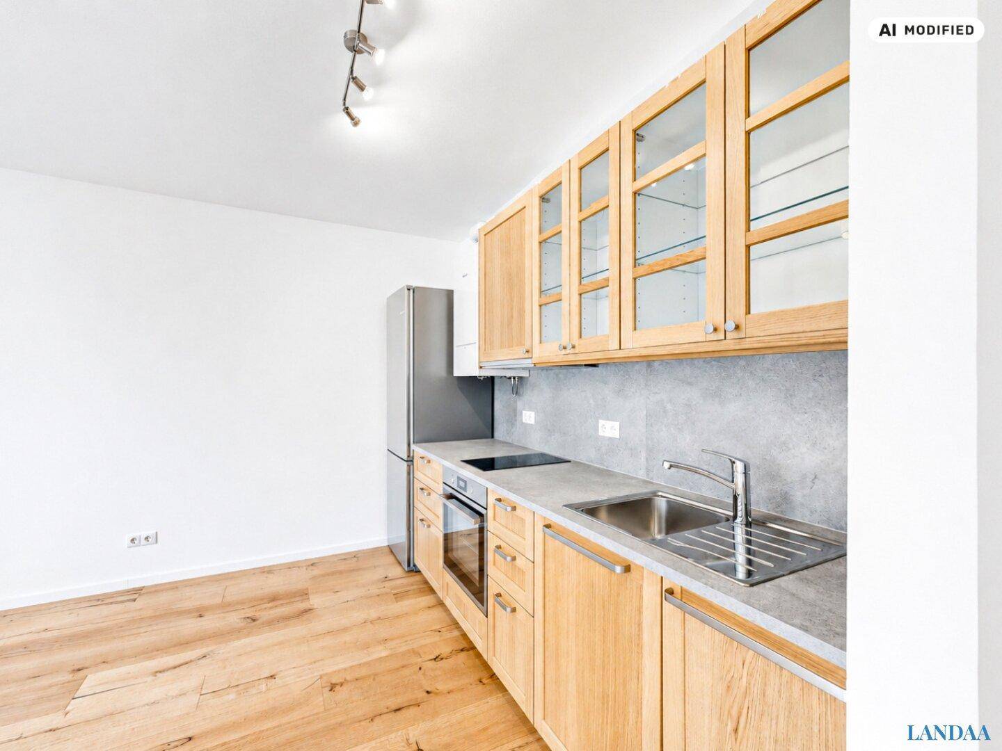 Moderne Einbauküche mit Holzfronten, grauer Arbeitsplatte und integrierten Geräten.