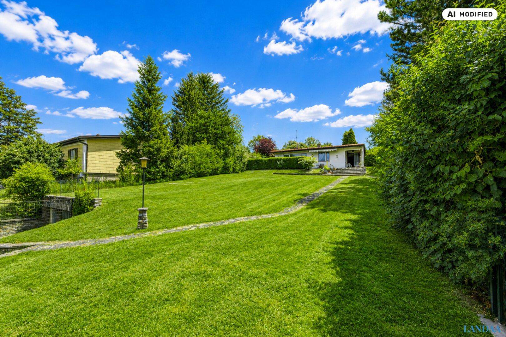 Weitläufiger Garten mit gepflegtem Rasen und Blick auf das Einfamilienhaus in der Ferne.
