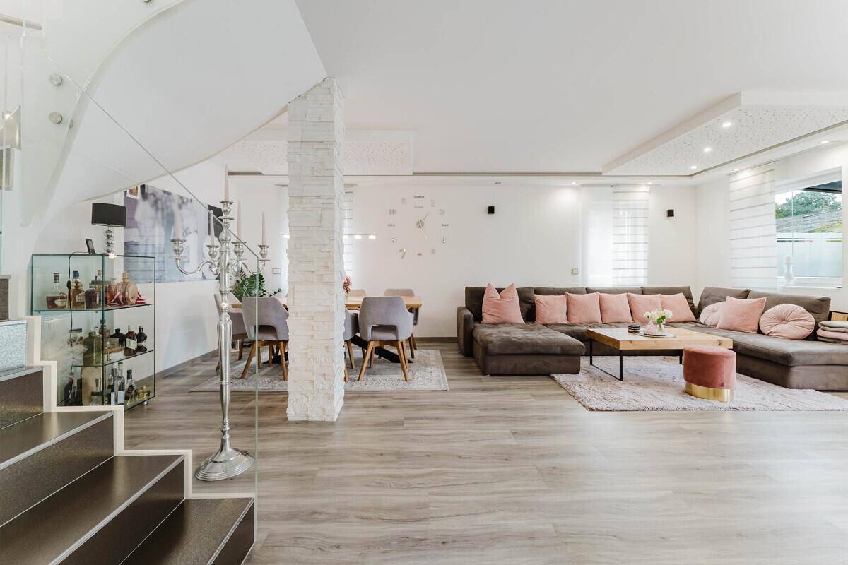 Offener Wohn- und Essbereich mit moderner Treppe und stilvoller Dekoration.