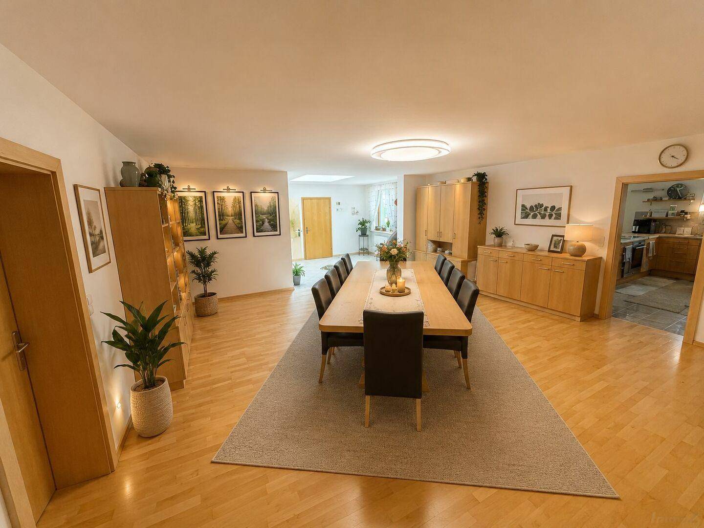 Heller Essbereich mit Holztisch und Stühlen, umgeben von modernen Möbeln und Dekoration.