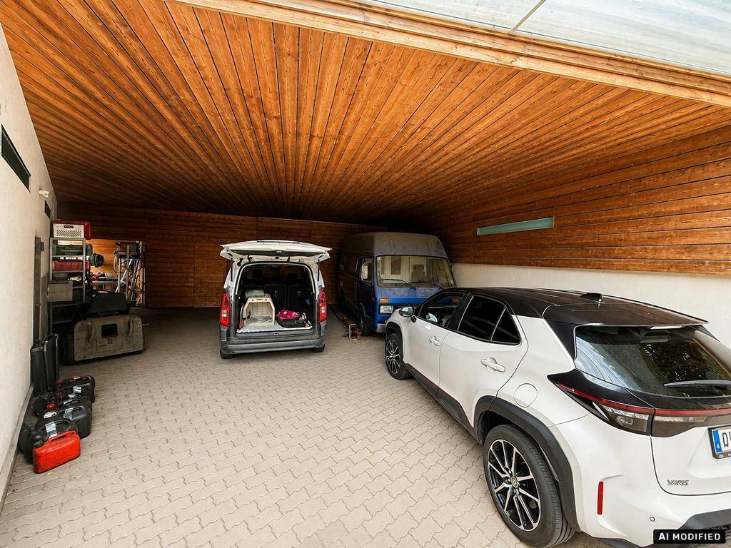Geräumiger Carport mit Holzdecke und Platz für mehrere Fahrzeuge.