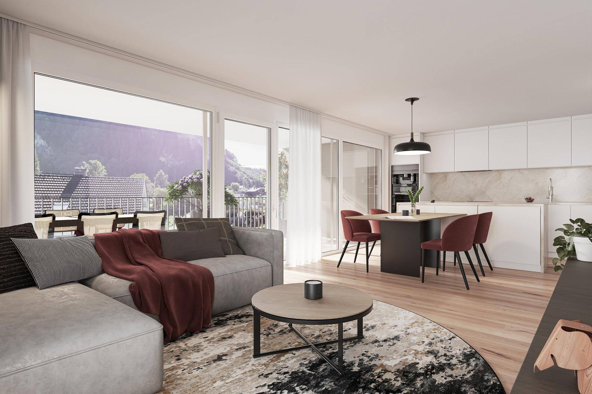 Heller offener Wohn-Essbereich mit integrierter Küche, Holzboden und Zugang zum Balkon.