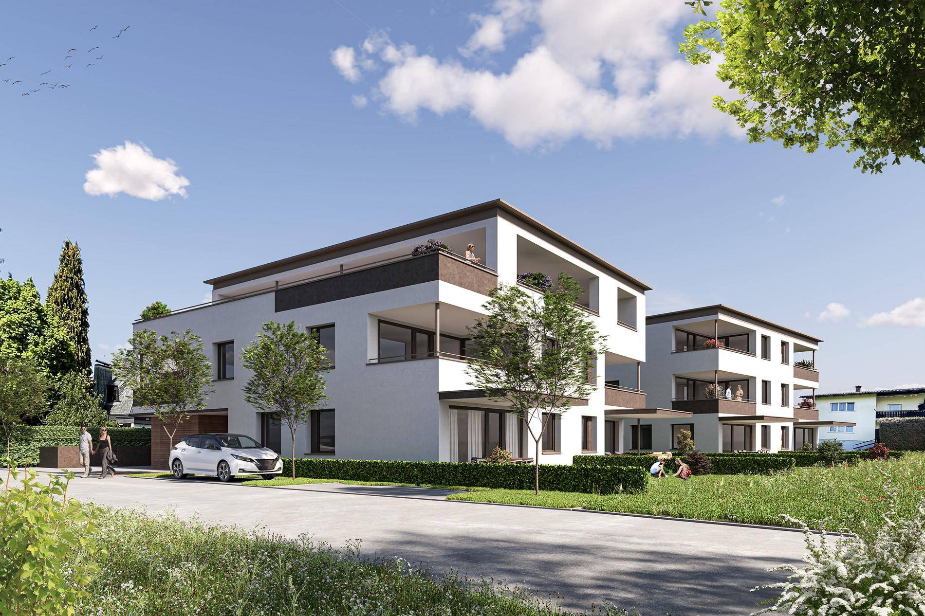 Moderne Wohngebäude mit Balkonen und gepflegten Grünflächen in einer ruhigen Umgebung.