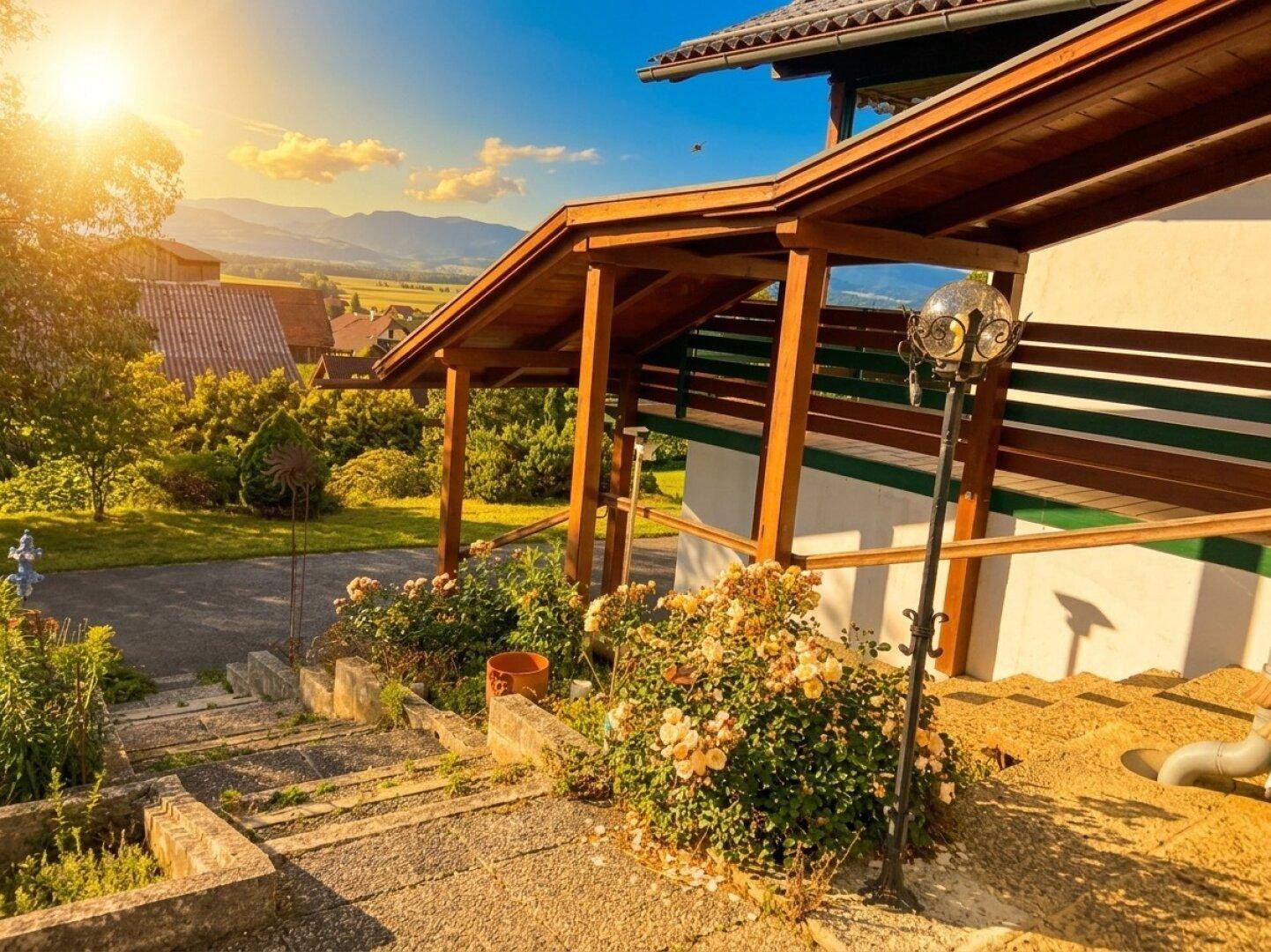 Überdachter Eingangsbereich mit Steintreppe und weitem Blick auf die Berge.