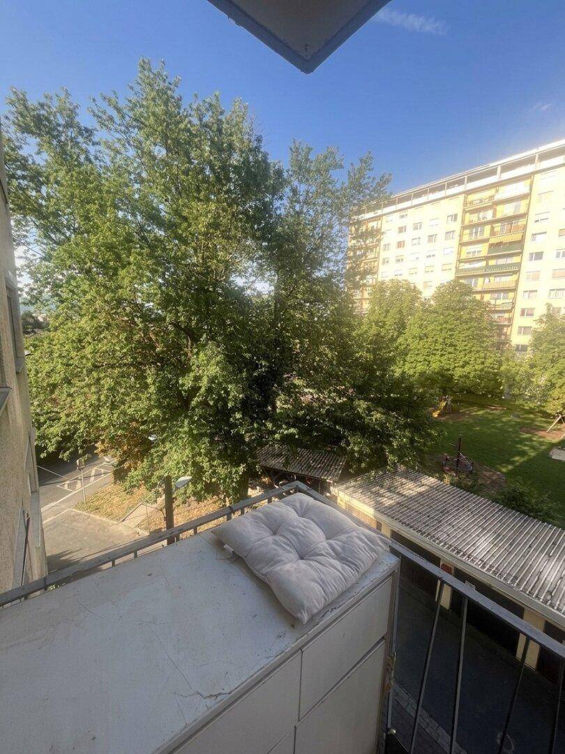 Balkon mit Blick ins Grüne und auf die umliegenden Wohngebäude, ideal zum Entspannen.