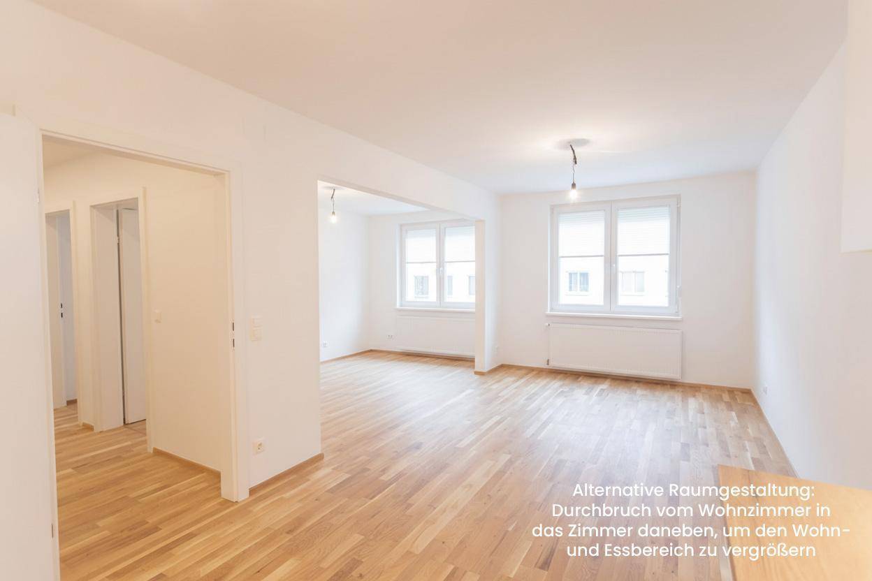 Heller Wohnbereich mit Holzboden und zwei Fenstern, offen gestaltet für einen größeren Essbereich.