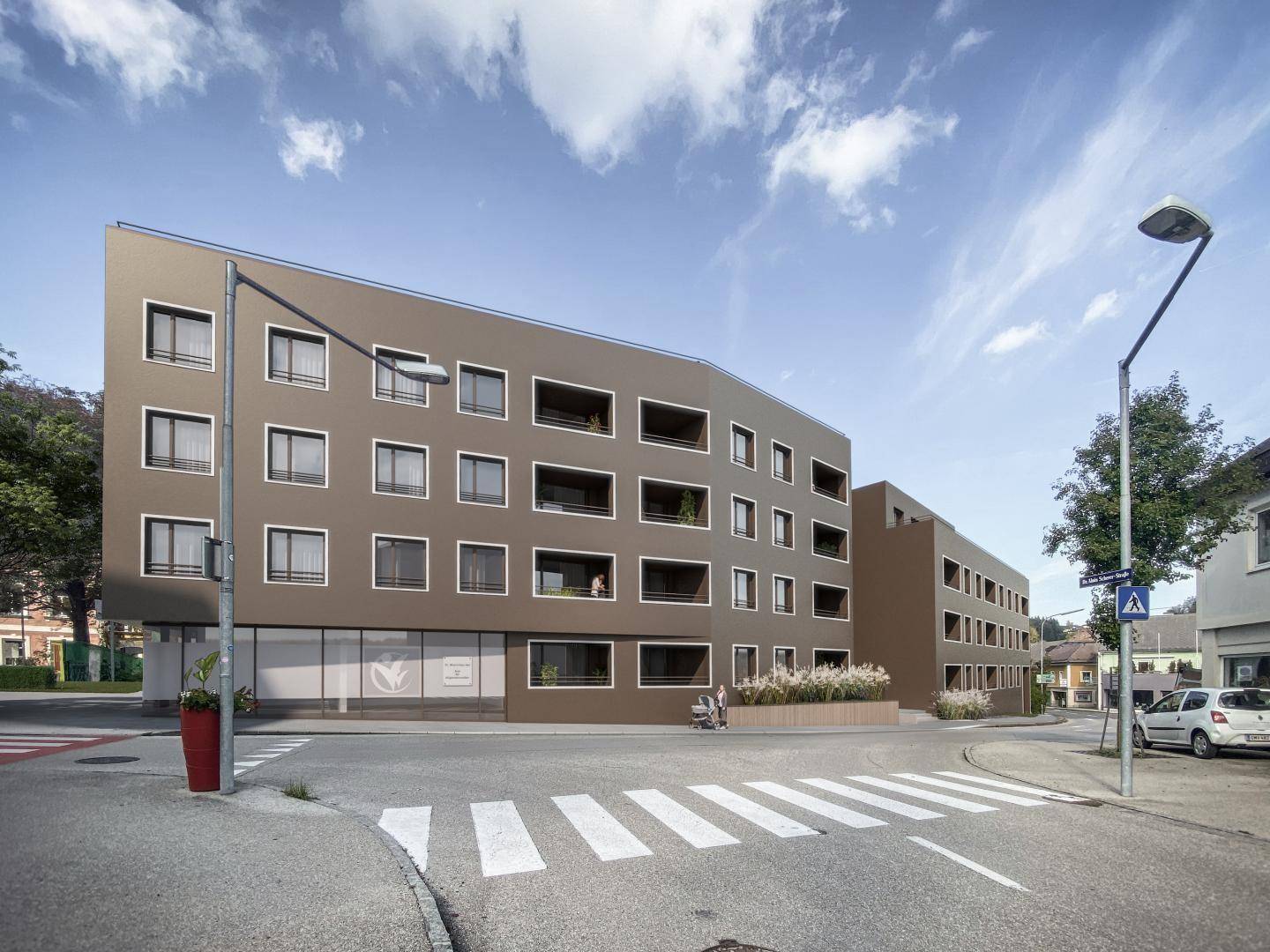Moderne Gebäudefassade mit klaren Linien und großen Fenstern an einer Straßenecke.