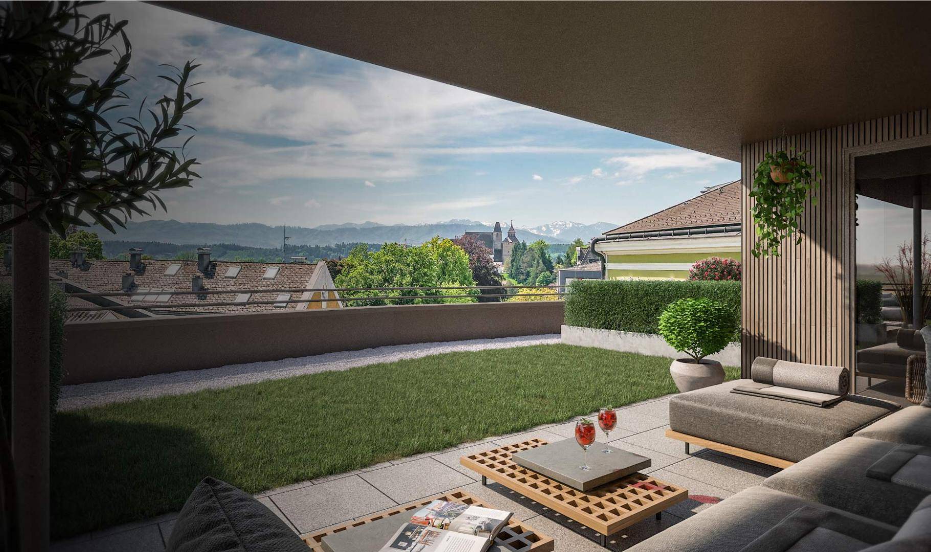 Großzügige Dachterrasse mit Rasenfläche, Sitzgelegenheiten und Bergblick.