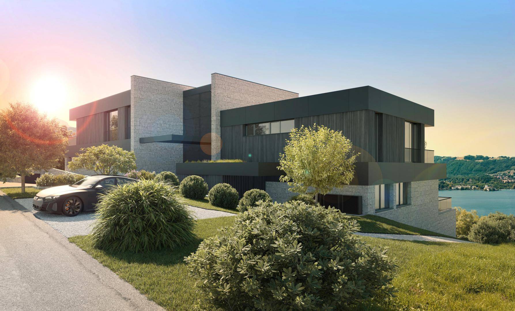 Moderne Architekturvilla mit Flachdach und Seeblick bei Sonnenuntergang.
