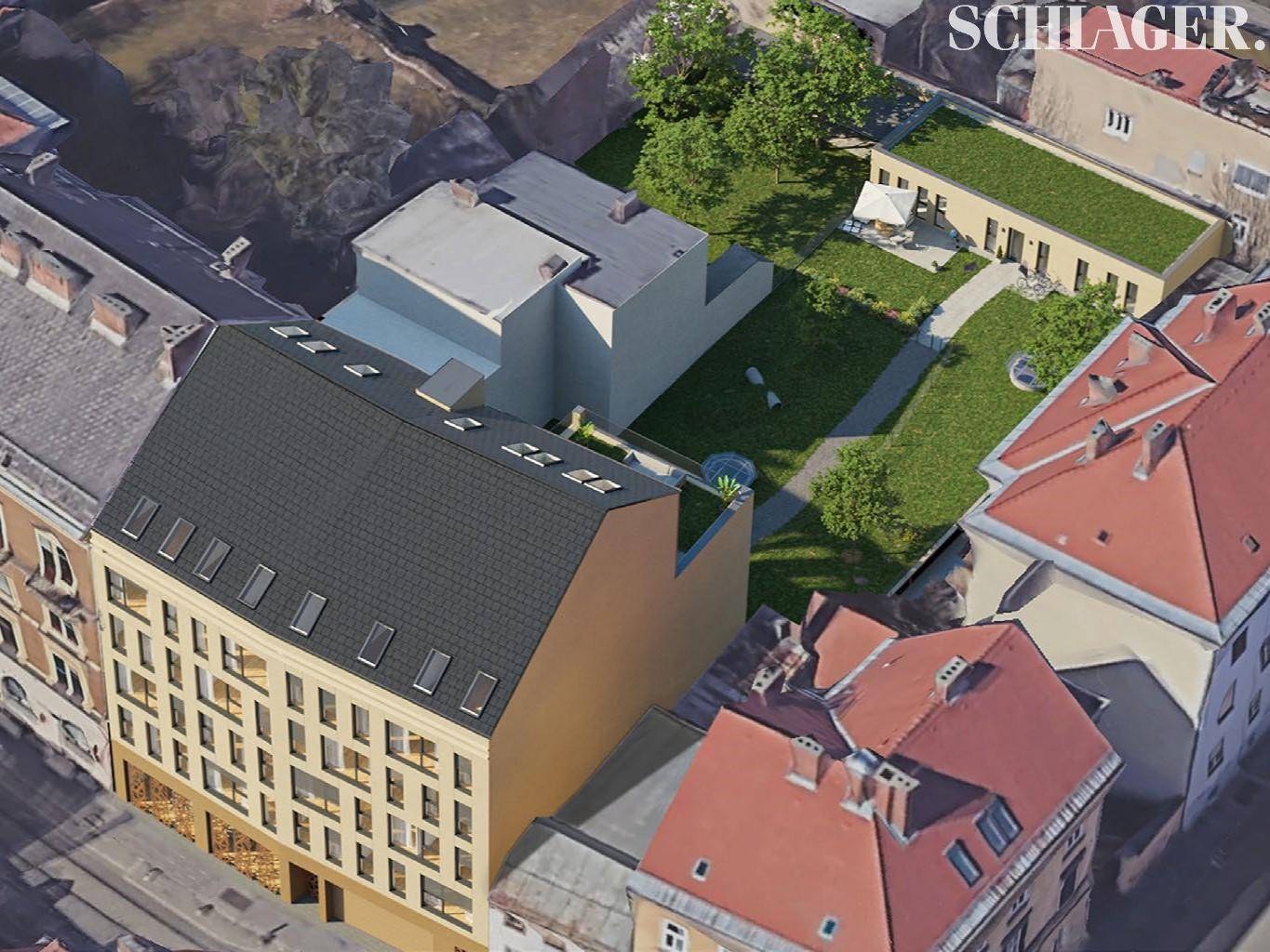 Luftaufnahme eines modernen Gebäudekomplexes mit begrünten Dächern und einem Innenhof mit Gartenanlage.