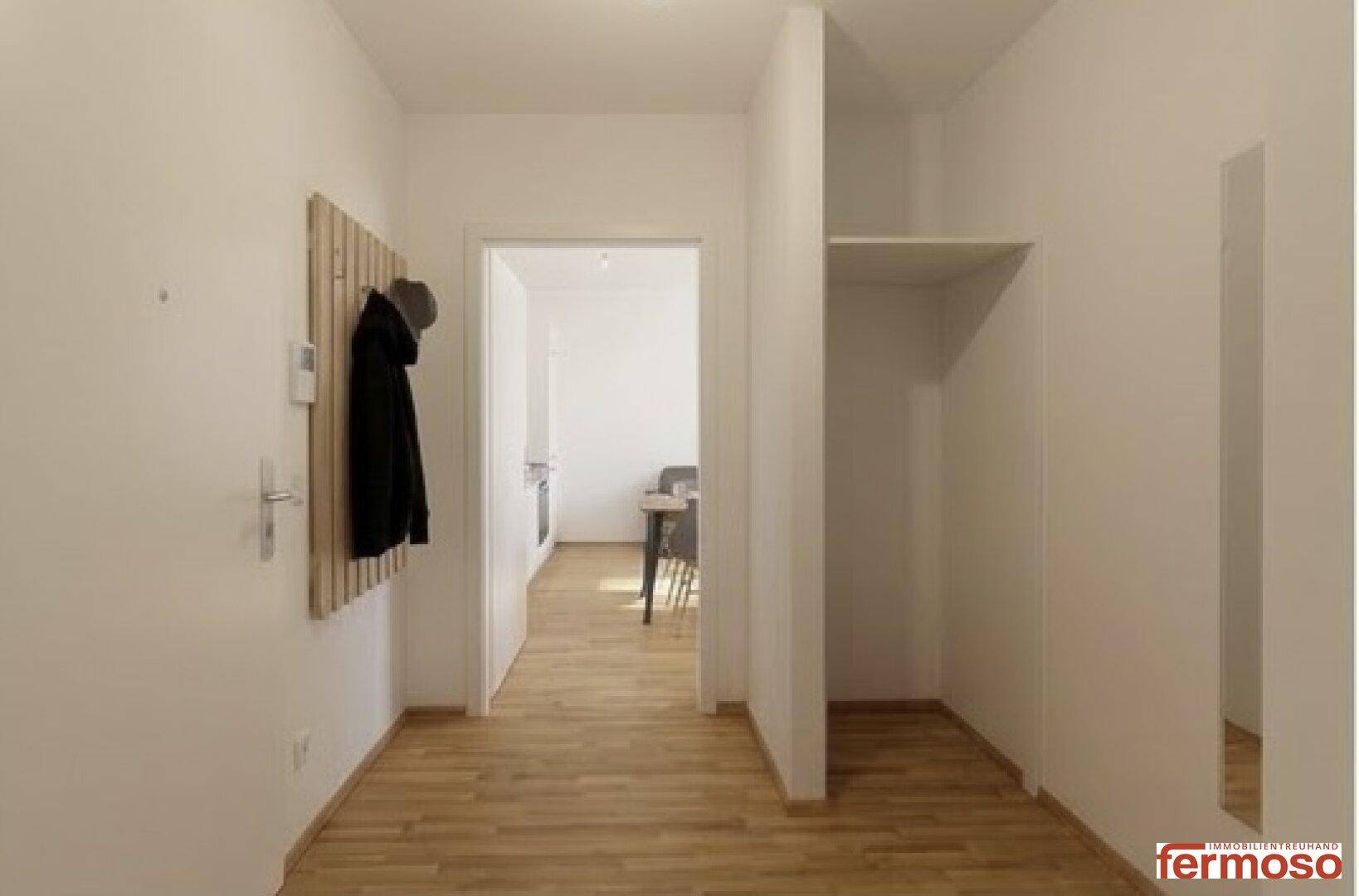 Heller Eingangsbereich mit Parkettboden und Garderobenwand.